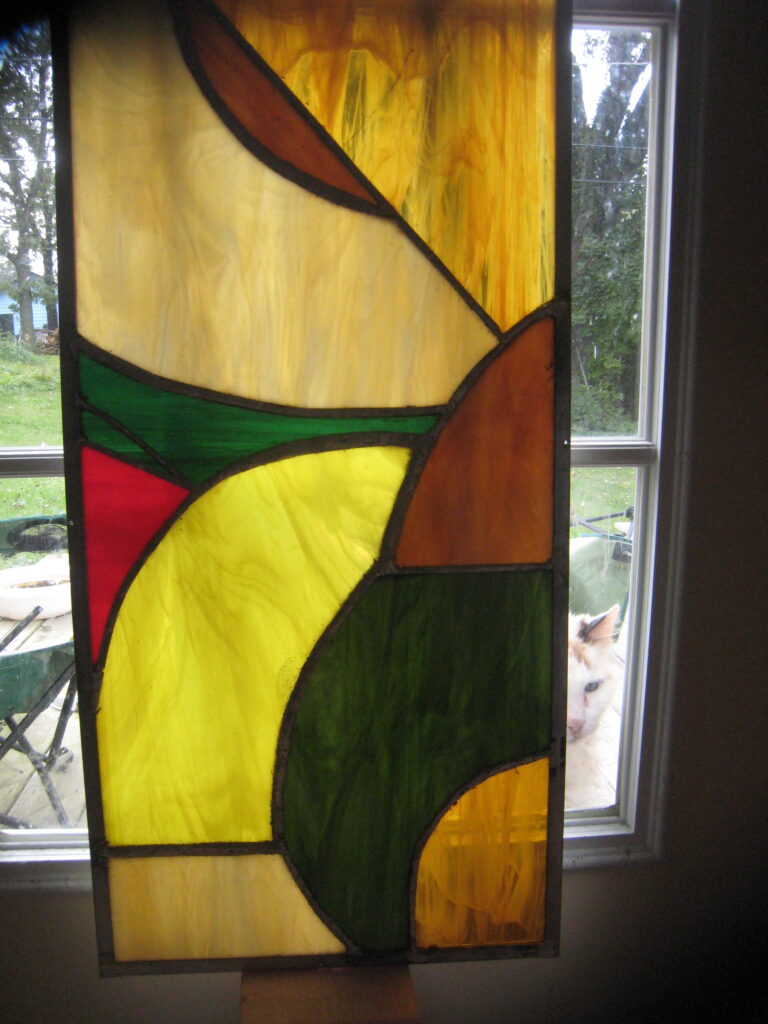 Curving stained-glass composition in green, amber, cream, and brown