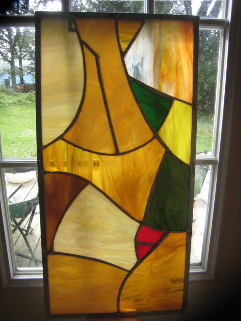 Angular stained-glass composition in amber, yellow, green, and cream