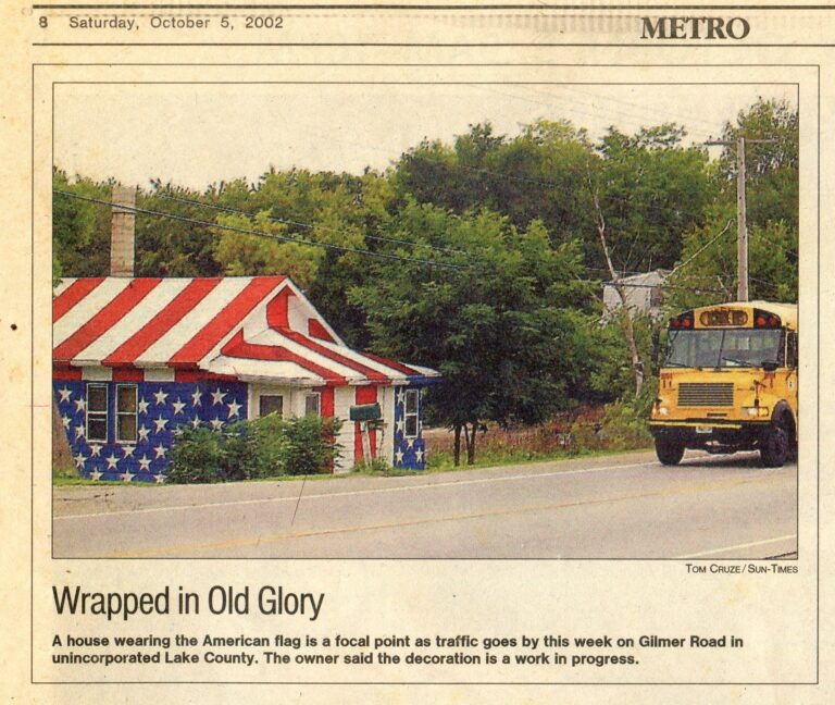 Newspaper clipping titled Wrapped in Old Glory, dated October 5, 2002