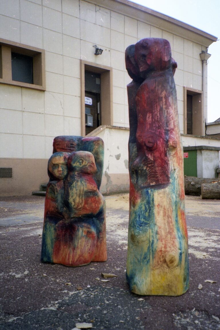 Colorful carved sculptures installed outside a building
