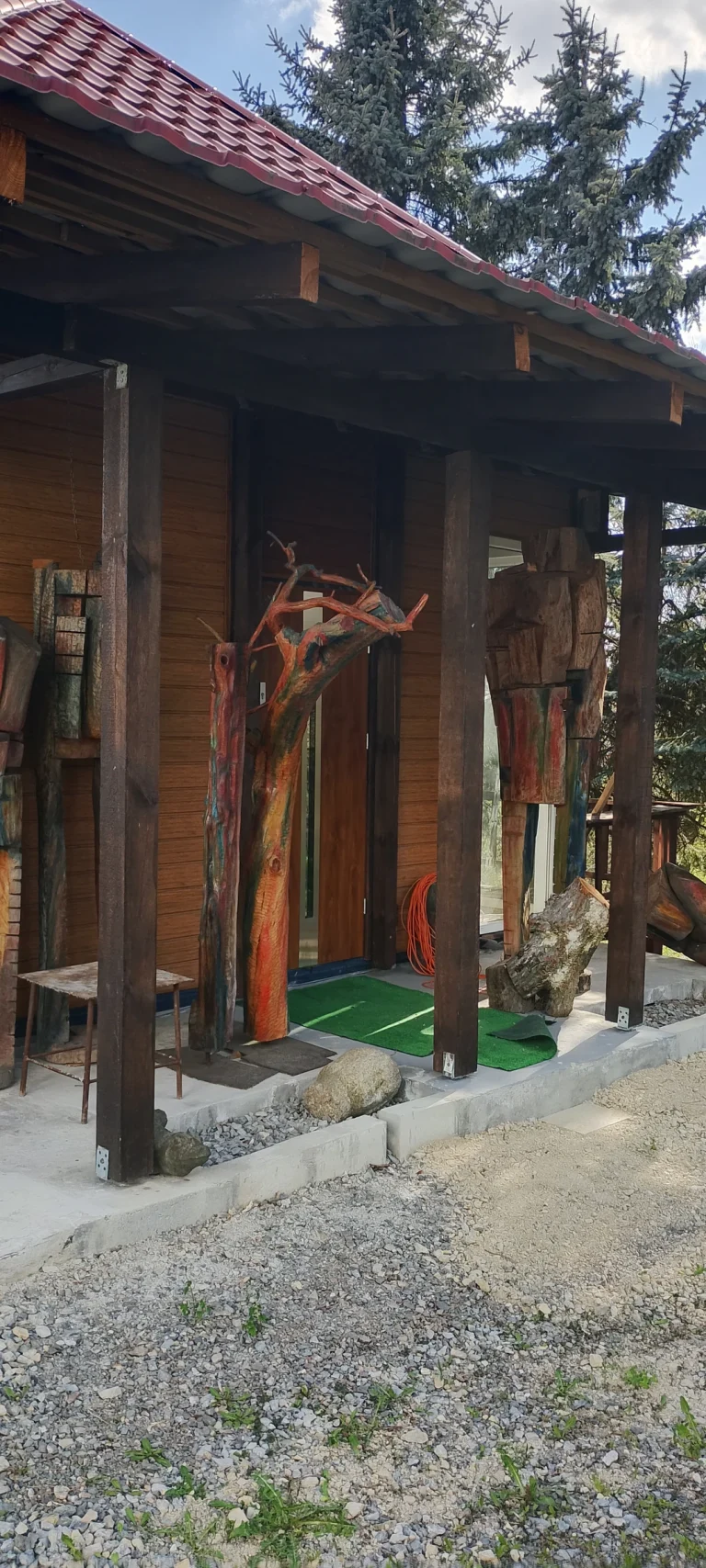 Painted wooden sculptures displayed outside the artist studio